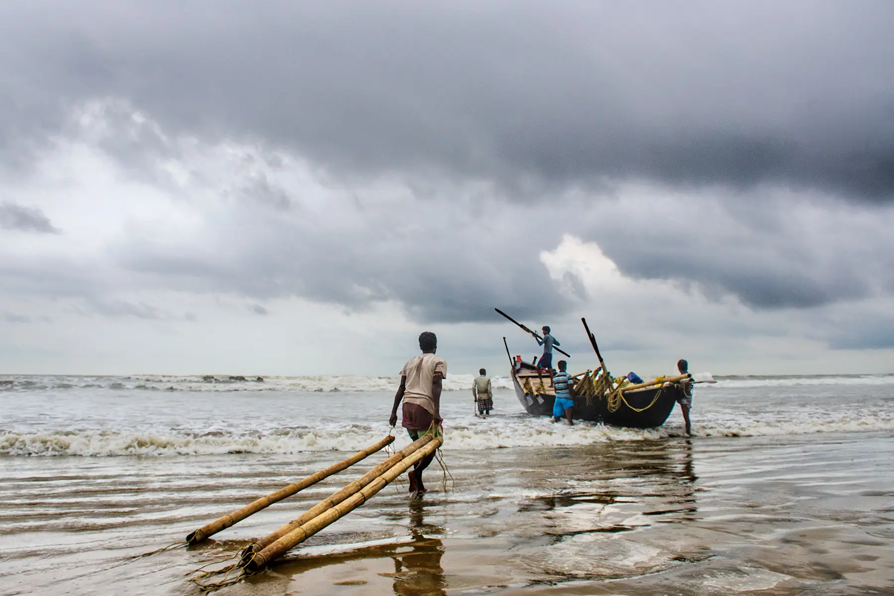 Fishermen Launching Boat At Sea by Twin Lens